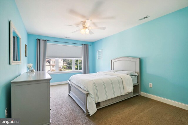 bedroom with ceiling fan, carpet flooring, visible vents, and baseboards