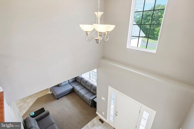 living room featuring carpet floors and a notable chandelier