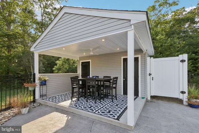 view of patio / terrace featuring ceiling fan, fence, and outdoor dining area