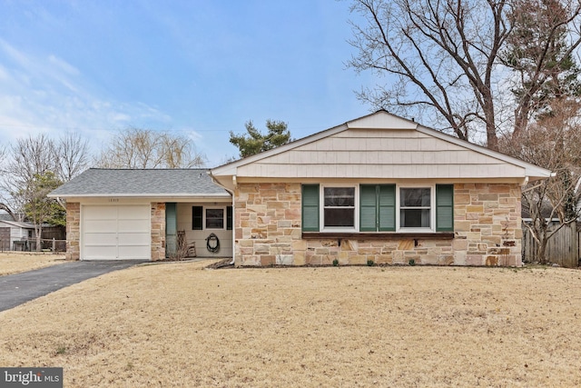 ranch-style home featuring driveway, stone siding, an attached garage, and a shingled roof