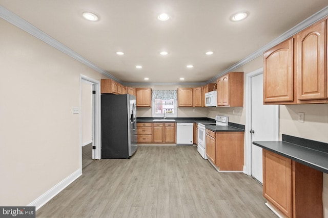 kitchen with light wood finished floors, white appliances, dark countertops, and crown molding