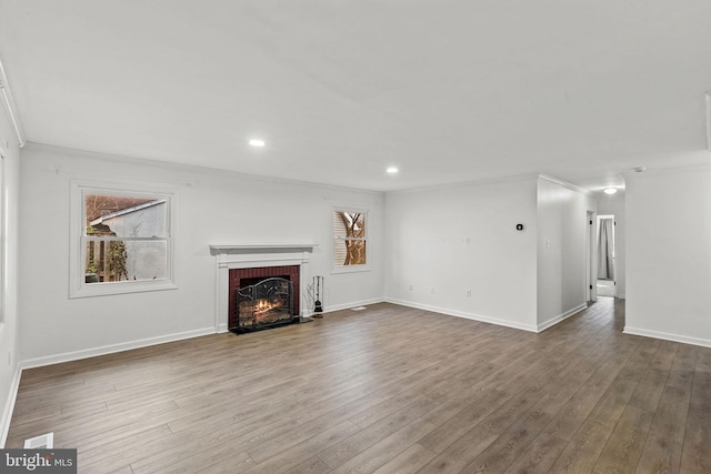 unfurnished living room featuring recessed lighting, a fireplace, wood finished floors, and baseboards