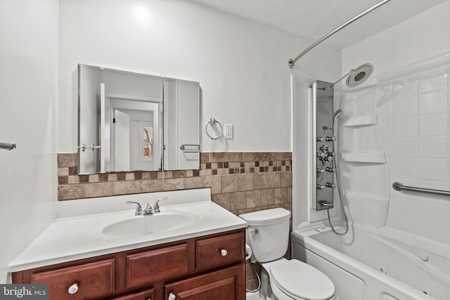 full bath with shower / washtub combination, toilet, tile walls, and vanity