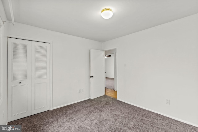 unfurnished bedroom featuring carpet floors, a closet, and baseboards