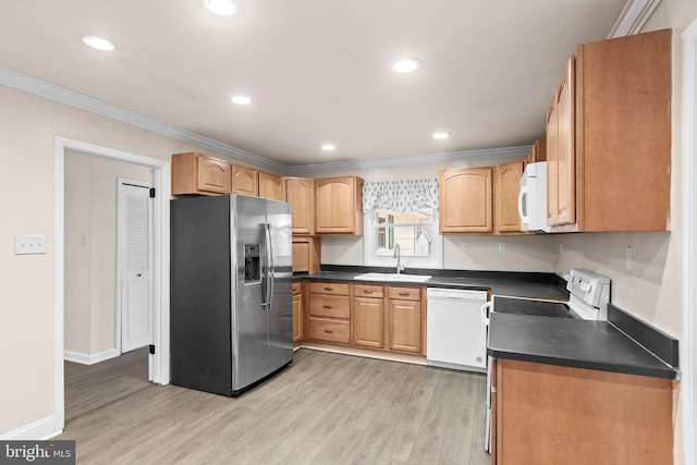 kitchen with crown molding, dark countertops, light wood-style floors, a sink, and white appliances