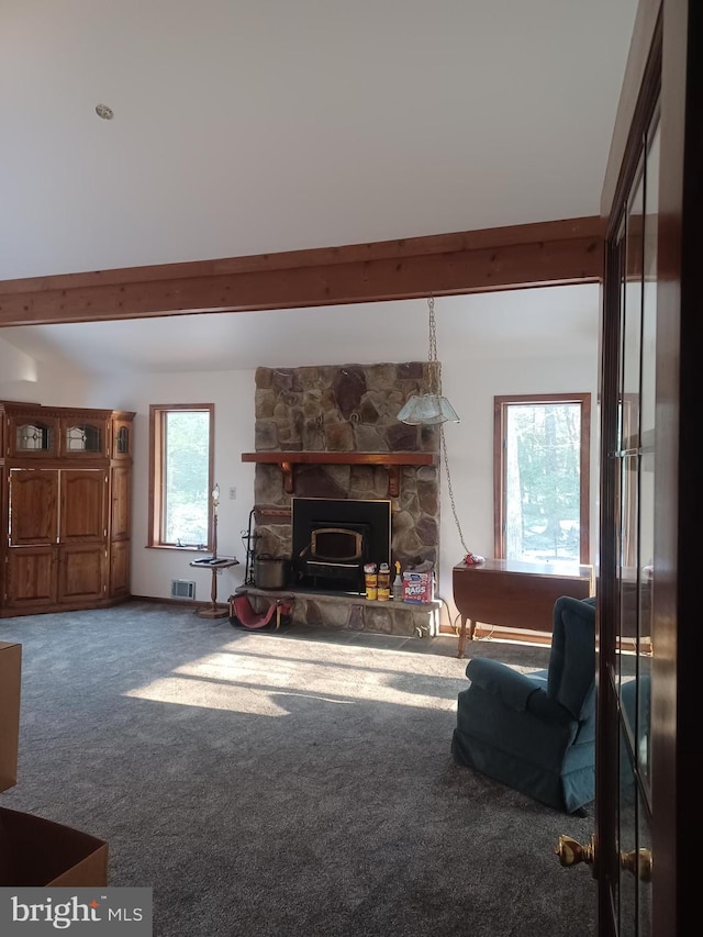 carpeted living room with beam ceiling and visible vents