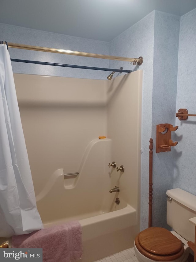 bathroom with shower / bath combination with curtain and toilet