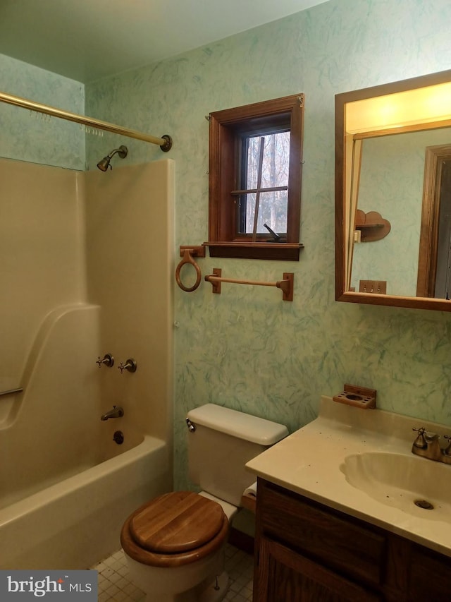 bathroom with bathing tub / shower combination, wallpapered walls, toilet, vanity, and tile patterned floors