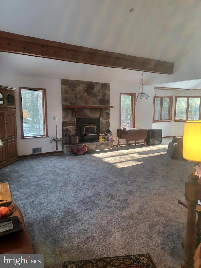 carpeted living area featuring beamed ceiling, plenty of natural light, and visible vents