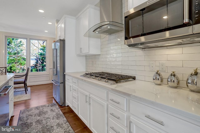 kitchen with dark wood finished floors, island exhaust hood, stainless steel appliances, decorative backsplash, and white cabinetry