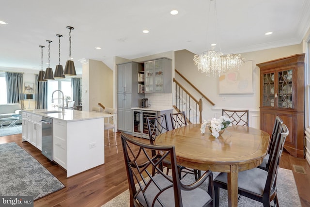 dining area with wine cooler, dark wood-style floors, and ornamental molding