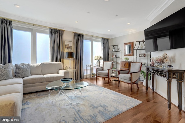 living area with crown molding, recessed lighting, and wood finished floors