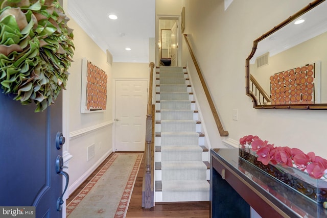 foyer entrance with visible vents, recessed lighting, ornamental molding, and wood finished floors