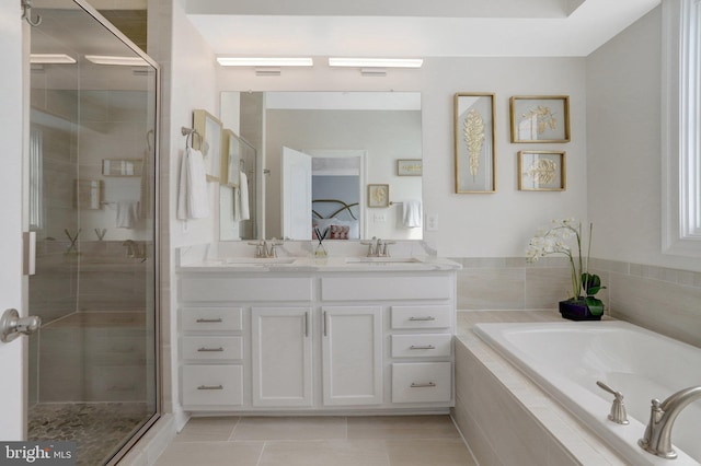 full bathroom featuring a shower stall, connected bathroom, double vanity, and a sink