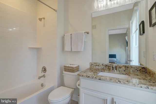 ensuite bathroom featuring vanity, shower / bath combination, toilet, and connected bathroom