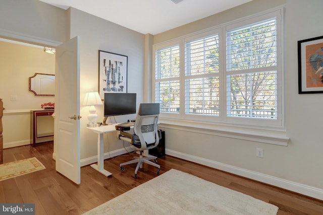 office area with wood finished floors and baseboards