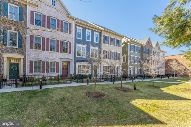 view of building exterior with a residential view and fence