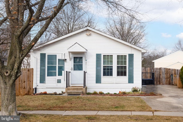 bungalow-style home featuring fence and a front yard