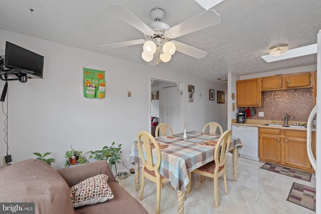 dining space with a textured ceiling, ceiling fan, and light tile patterned floors