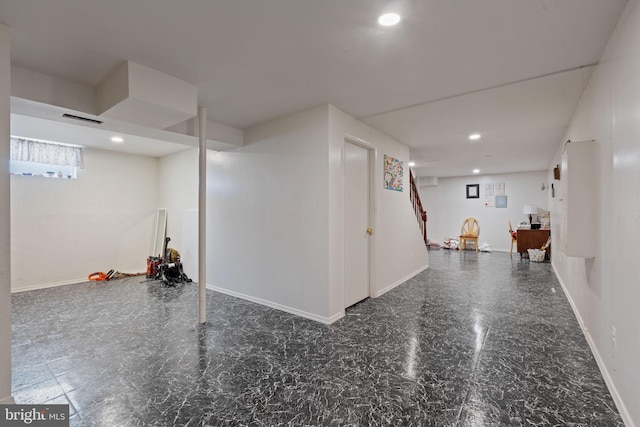 basement with baseboards, visible vents, and recessed lighting