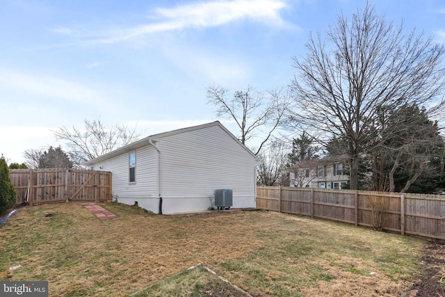 exterior space with central AC and a fenced backyard