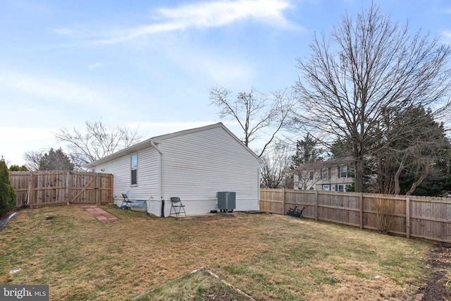 exterior space featuring a lawn, cooling unit, and a fenced backyard