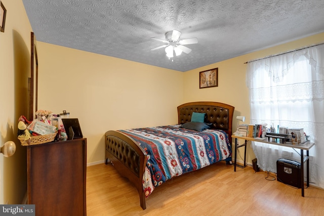 bedroom featuring a textured ceiling and wood finished floors