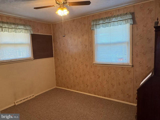 carpeted empty room with wallpapered walls, a baseboard radiator, baseboards, and a ceiling fan