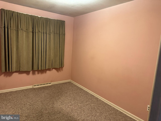 spare room with baseboards, visible vents, and carpet flooring