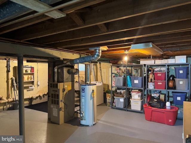 unfinished basement featuring water heater, heating unit, and separate washer and dryer