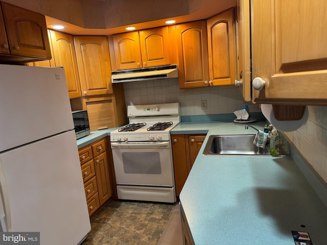 kitchen featuring under cabinet range hood, white appliances, light countertops, backsplash, and brown cabinetry