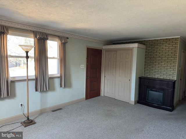 unfurnished living room featuring a textured ceiling, carpet flooring, and baseboards