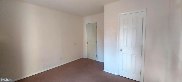 unfurnished bedroom with carpet floors and baseboards