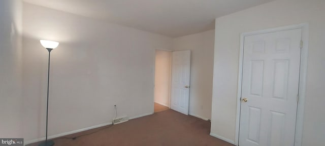 unfurnished bedroom featuring carpet floors, visible vents, and baseboards