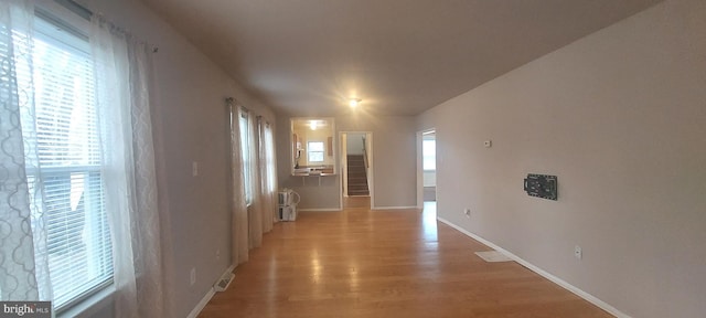 interior space with light wood-type flooring and baseboards