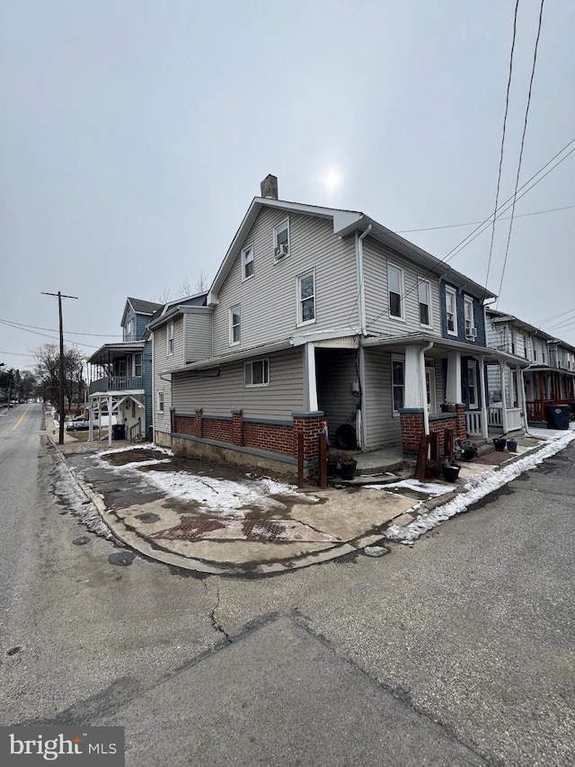 view of front of property with a porch and a chimney