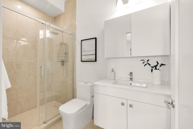 bathroom with toilet, a shower stall, and vanity