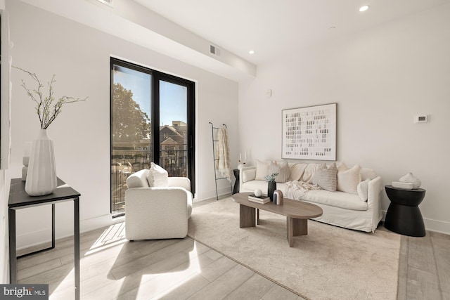 living area with visible vents, recessed lighting, baseboards, and wood finished floors