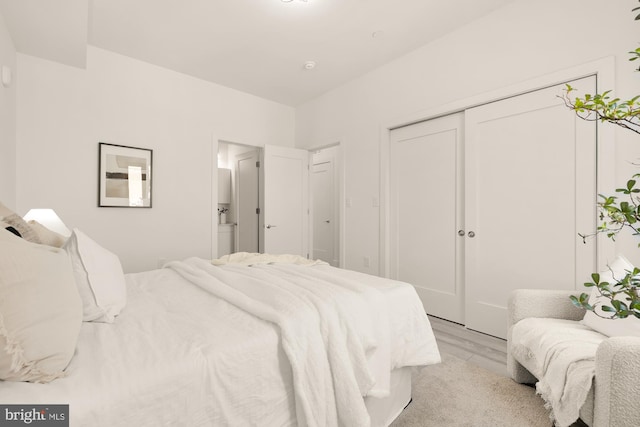 bedroom featuring light wood-type flooring and a closet