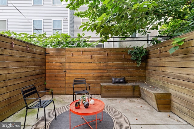 view of patio featuring fence