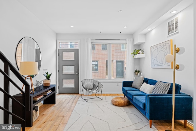 interior space with baseboards, visible vents, stairway, wood finished floors, and recessed lighting