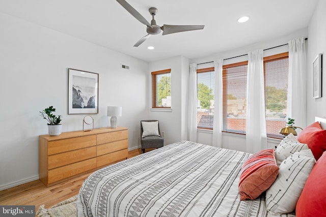 bedroom featuring visible vents, baseboards, light wood-style flooring, ceiling fan, and recessed lighting