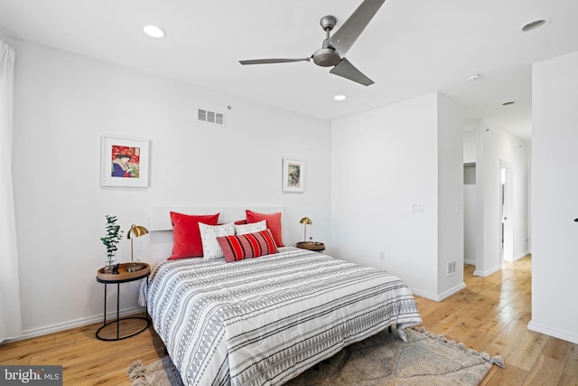 bedroom featuring light wood-type flooring, visible vents, baseboards, and recessed lighting