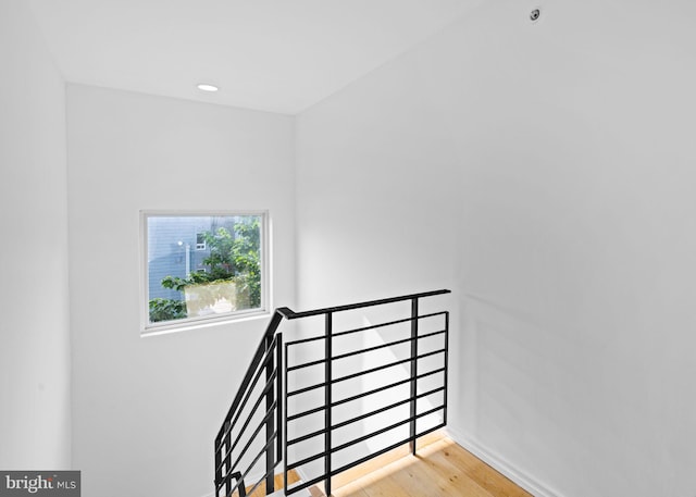 staircase featuring baseboards and wood finished floors