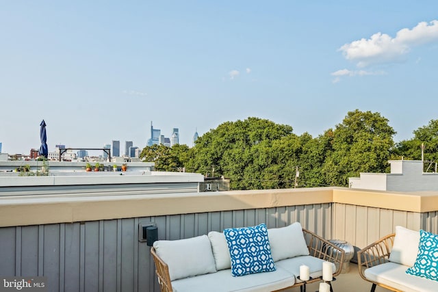 balcony with a city view and an outdoor hangout area