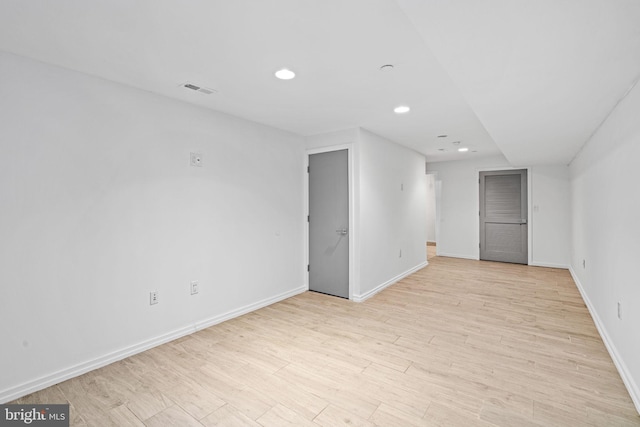 below grade area with light wood-style floors, baseboards, visible vents, and recessed lighting