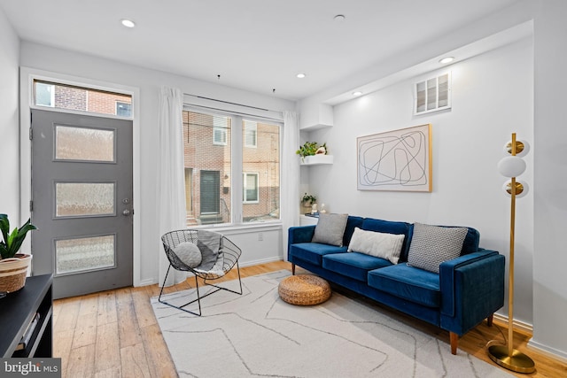 living room featuring recessed lighting, visible vents, and wood finished floors