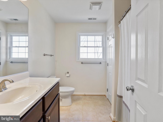 full bath featuring vanity, toilet, visible vents, and tile patterned flooring