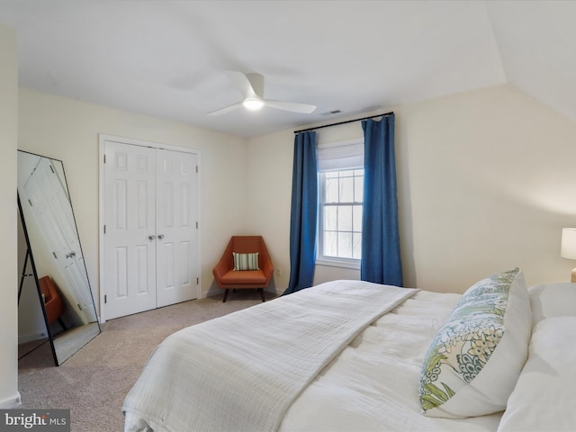 bedroom with a closet, ceiling fan, lofted ceiling, and carpet