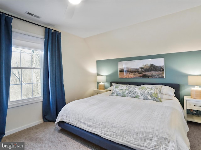 bedroom featuring visible vents, baseboards, and carpet